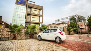 A modern building with a sign for 'Aakran Shah Paradise' and 'Fab Hotels'.
