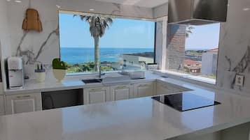 Luxury Townhome | Private kitchen | Full-size fridge, microwave, stovetop, rice cooker