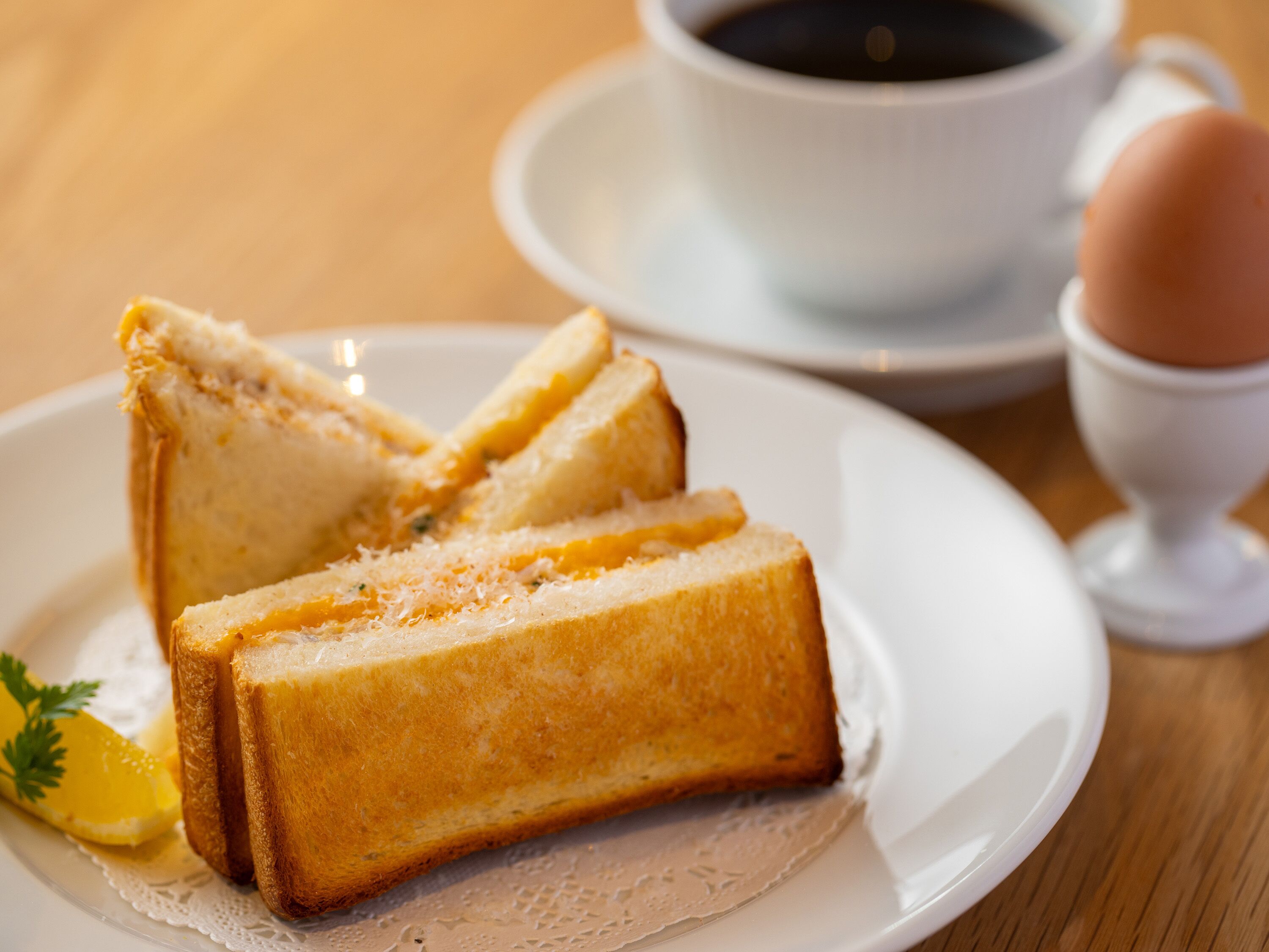 A plate with toast and a cup of coffee on a table.