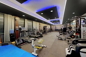 A gym with treadmills, weight machines, and free weights.