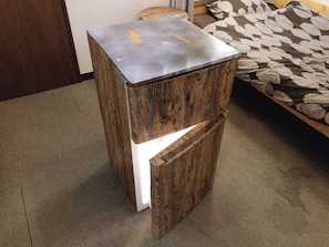A small wooden side table with a metallic top and a built-in shelf. - Top Edge Hostel (Tokyo)