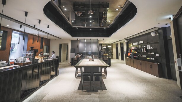 A modern kitchen with a central island, bar area, and built-in appliances.