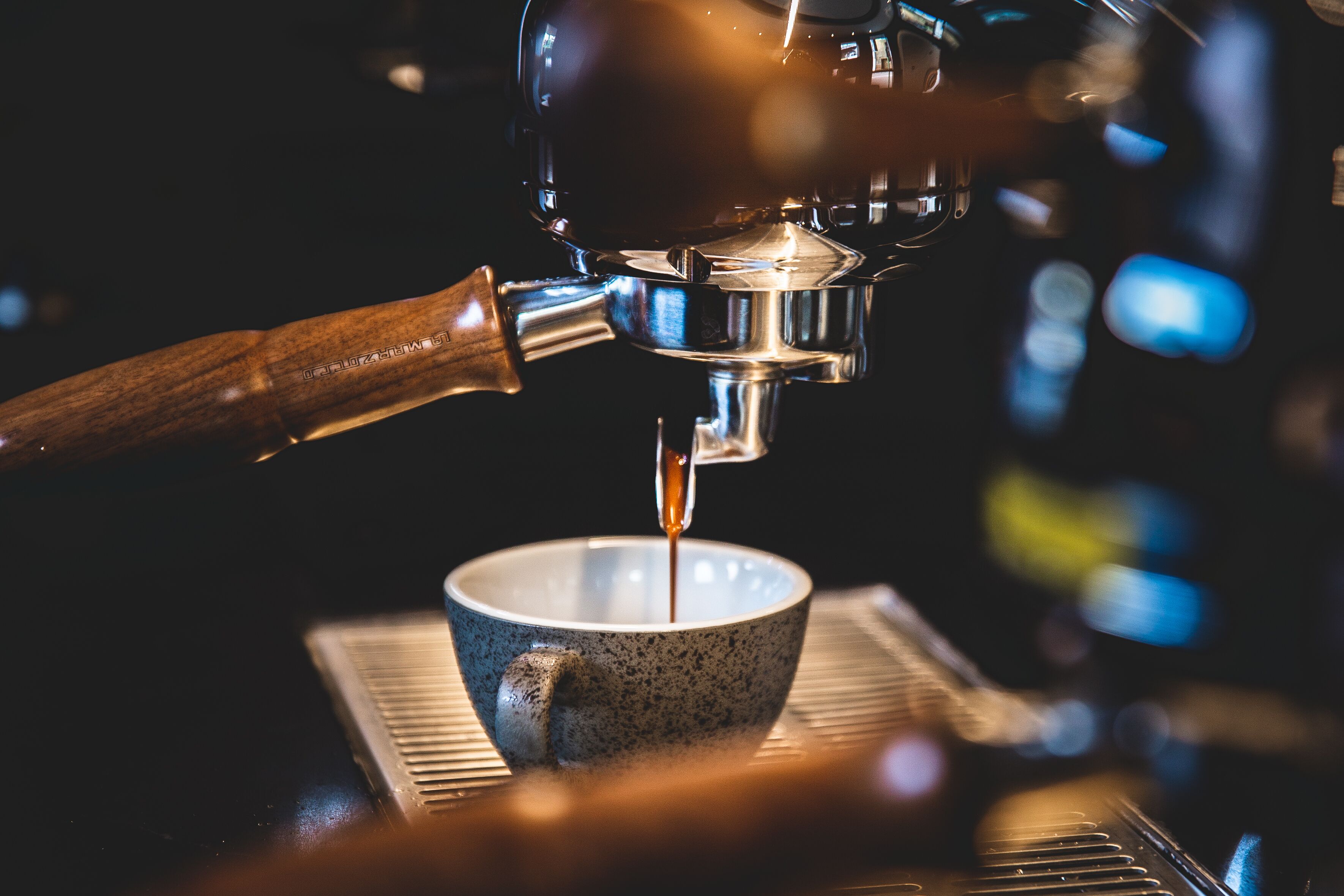 Primer plano de una cafetera sirviendo café en una taza.