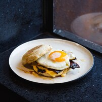 A breakfast sandwich on a plate.