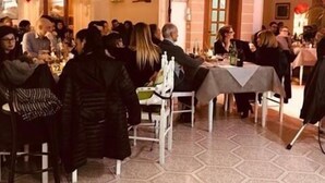 A crowded indoor event with tables and chairs, red balloons, and a brick wall. - Albergo 2 Mari (Castrignano del Capo)