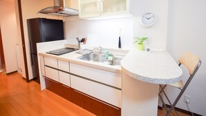 Apartment | Private kitchenette | Fridge, microwave, stovetop, electric kettle - Family Stay DOTONBORI III PH26 (Osaka)