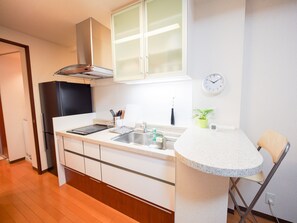 Apartment | Private kitchenette | Fridge, microwave, stovetop, electric kettle - Family Stay DOTONBORI III PH26 (Osaka)