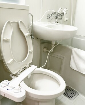 A bathroom with a toilet, bidet, and sink. - Tokyo Urban Flat Hotel 201 (Tokyo)