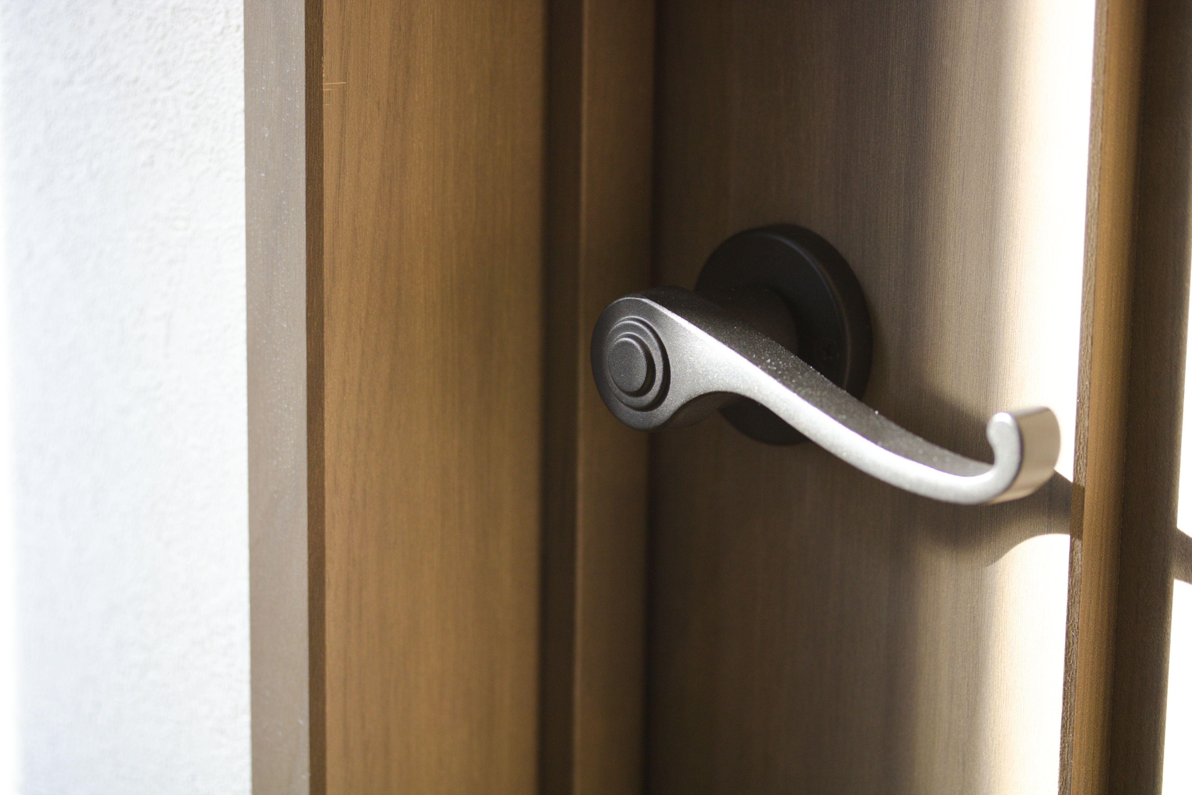 A door handle on a wooden door.