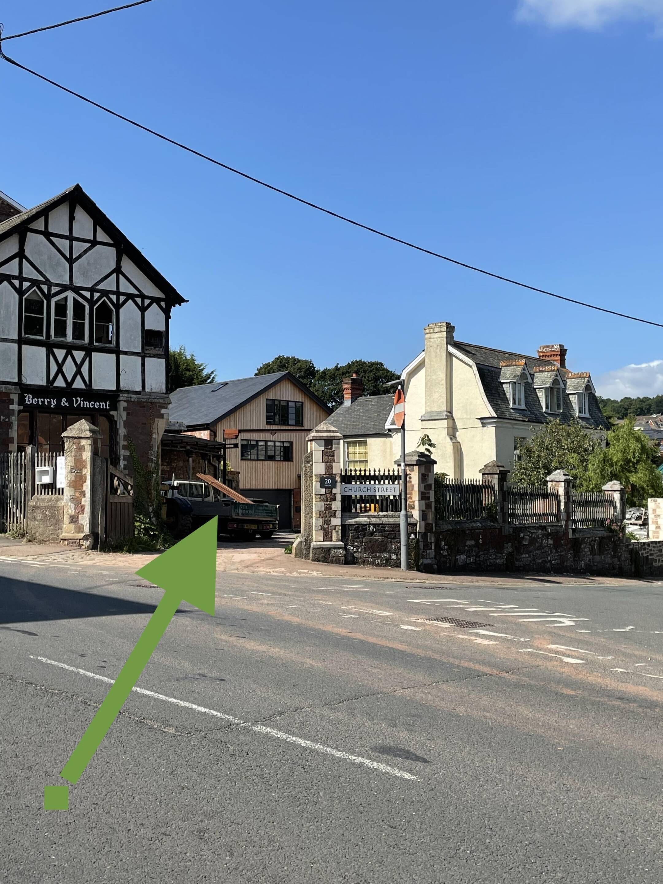 A street view with a Tudor-style building named 'Berry & Vincent' and a house labeled 'Church Street.'