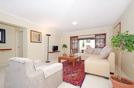 Deluxe Apartment, 2 Bedrooms, Garden View | Living room | Flat-screen TV