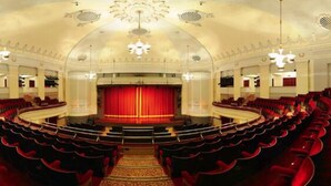 A grand theater with a central stage, rows of red seating, and ornate ceiling details. - Holiday Home With Hot Tub & Sauna (Bournemouth)