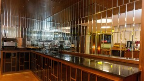 A modern bar area with a polished counter, stainless steel appliances, and a wooden floor. - Long Stay İstanbul Hotel (Istanbul)