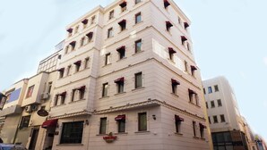 A multi-story hotel with a classic architectural design, featuring a prominent "Long Stay" sign on the ground floor. - Long Stay İstanbul Hotel (Istanbul)