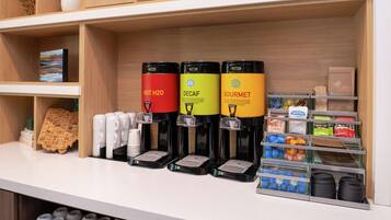A coffee station with three dispensers labeled HOT H2O, DECAF, and GOURMET.