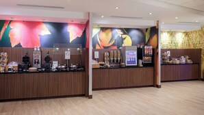 A modern reception area with a wooden counter, a coffee machine, and a fruit display. - Fairfield Inn & Suites by Marriott Augusta Washington Rd./I-20 (Augusta)