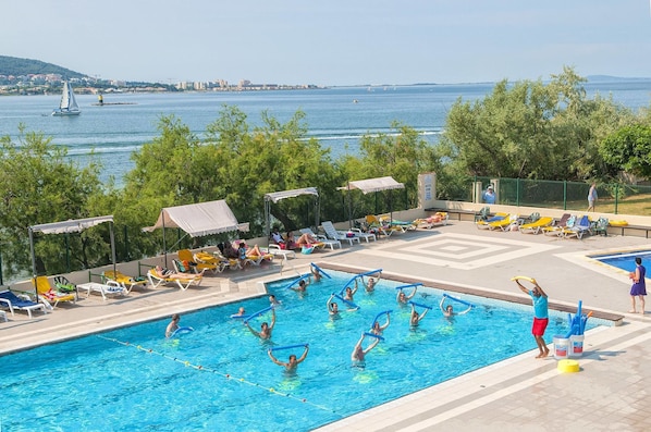 Outdoor pool, open 9:00 AM to 7:00 PM, pool umbrellas, pool loungers