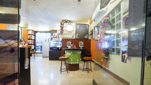 A bar area with stools, a counter, and a chalkboard menu. - RedDoorz Plus near San Pedro Cathedral (Davao)