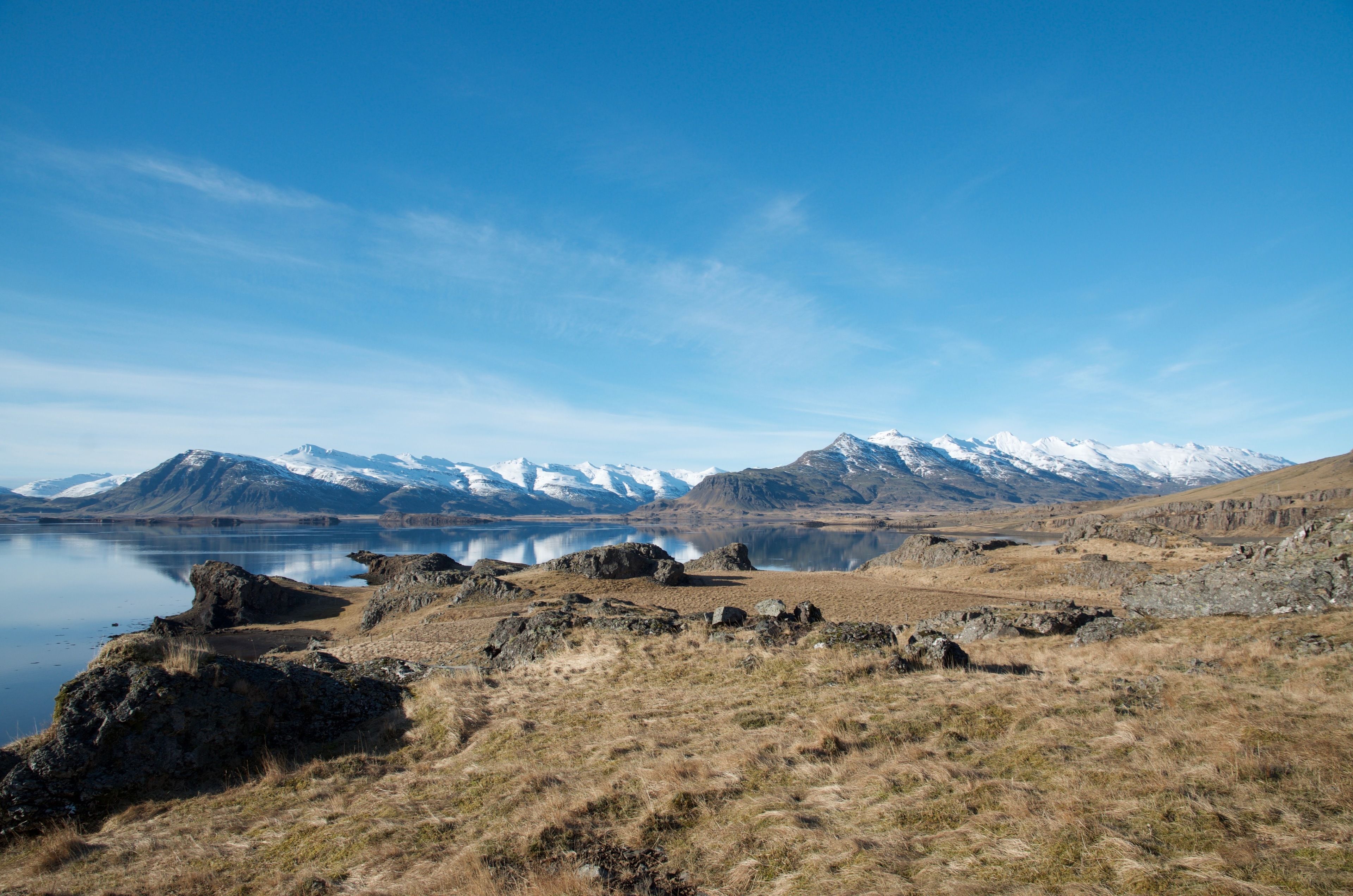 A mountainous landscape with a lake and rocky terrain.