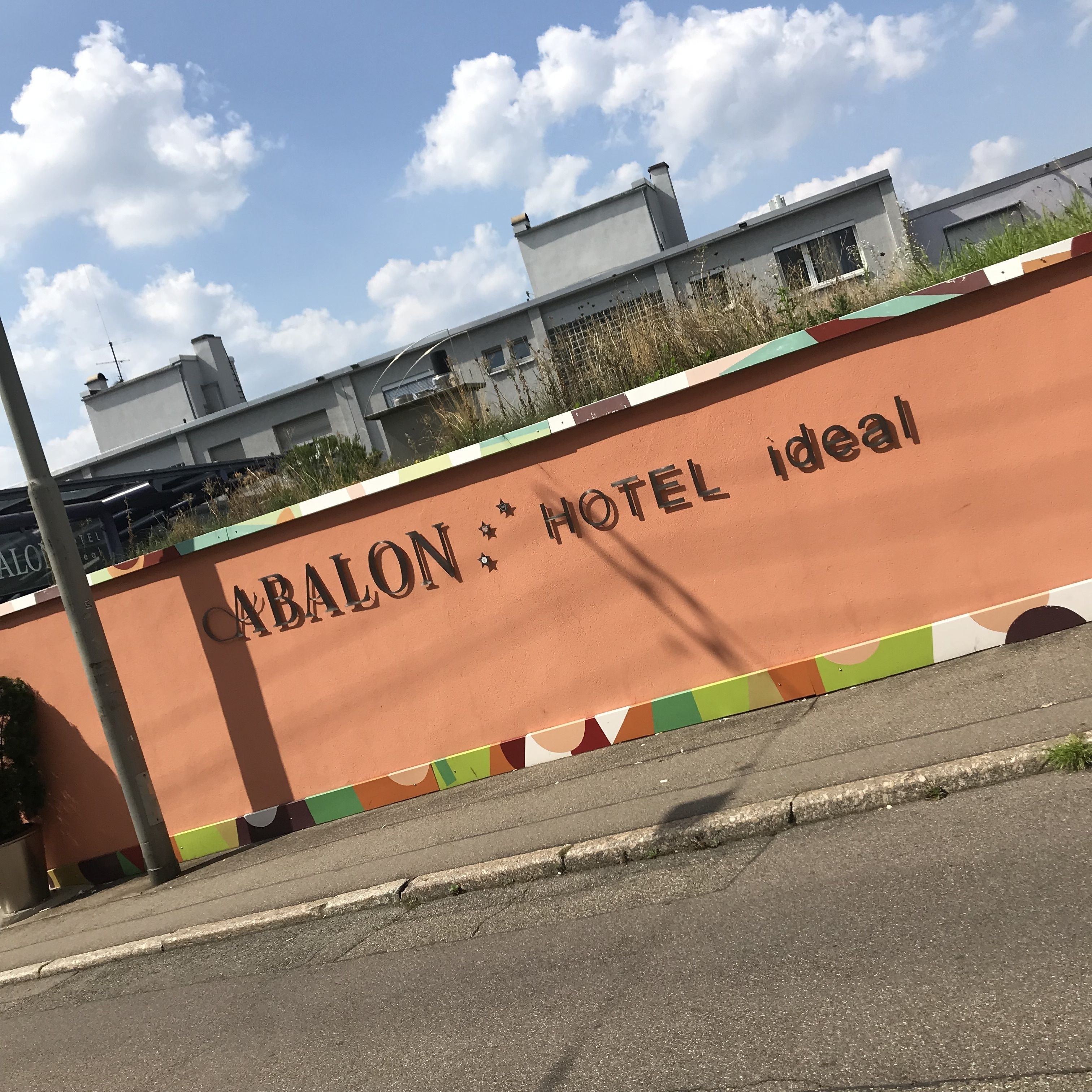 A sign for "ABALON HOTEL Ideal" with a clear view of the building's exterior.