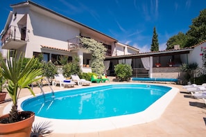 Seasonal outdoor pool, pool loungers