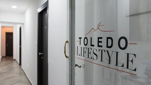 A hallway with a glass door labeled "TOLEDO LIFESTYLE". - Toledo Lifestyle (Naples)