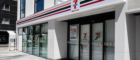 A 7-Eleven store with a modern facade, large glass windows, and a clear entrance.