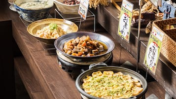 A buffet with various dishes and labels in a restaurant setting.