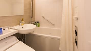 A modern bathroom with a toilet, sink, and bathtub.