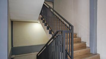 A staircase with wooden steps and black metal railings.