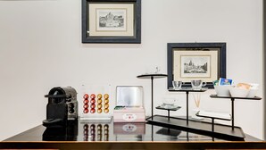 A reception desk with a coffee machine, a card reader, and a framed picture on the wall. - Residenza Le Gemelle di Roma (Rome)
