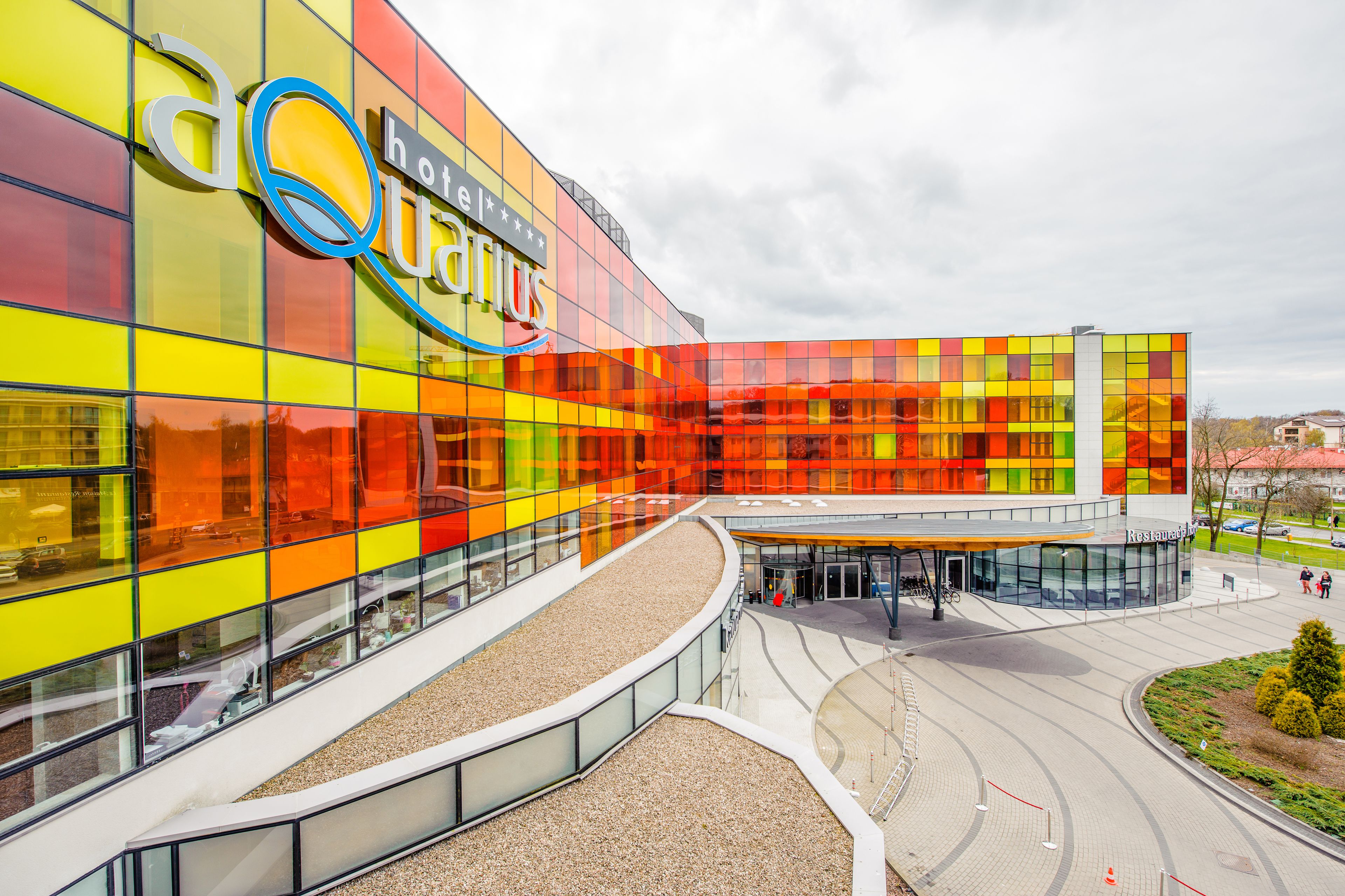 A modern hotel with a colorful facade and a spacious entrance area.