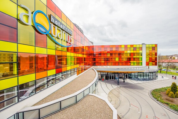 A modern hotel with a colorful facade and a spacious entrance area.