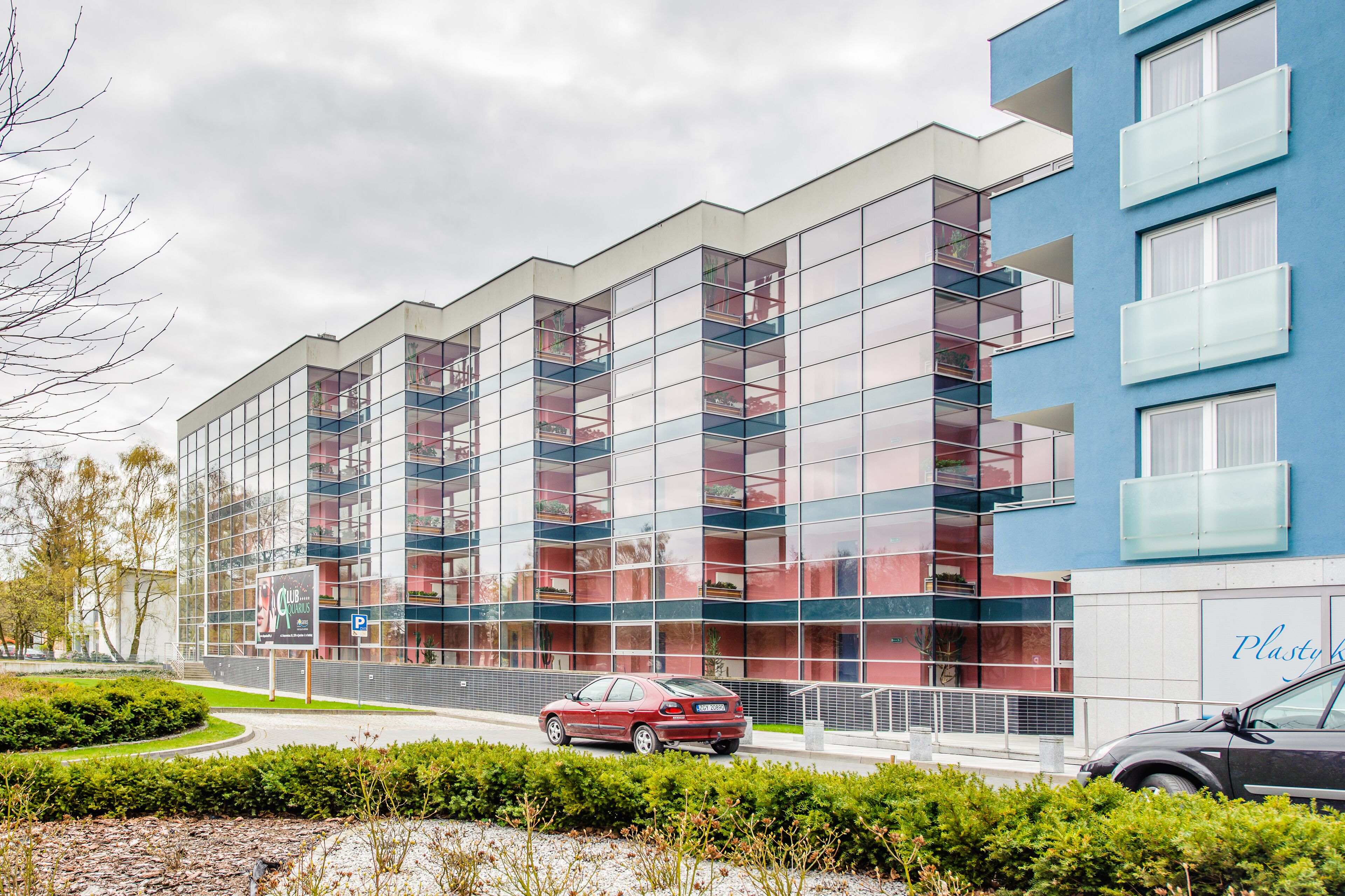 A modern building with multiple balconies and large windows.