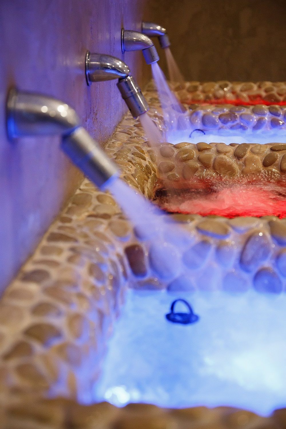 A close-up of a water feature with multiple faucets.