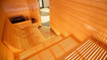 A sauna room with wooden slats and a bench.
