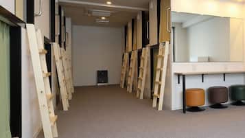 A corridor with wooden ladders, a mirror, and a bench.