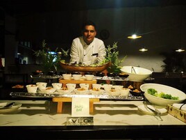 A buffet setup with labeled sections for salad bar and vegetarian options.