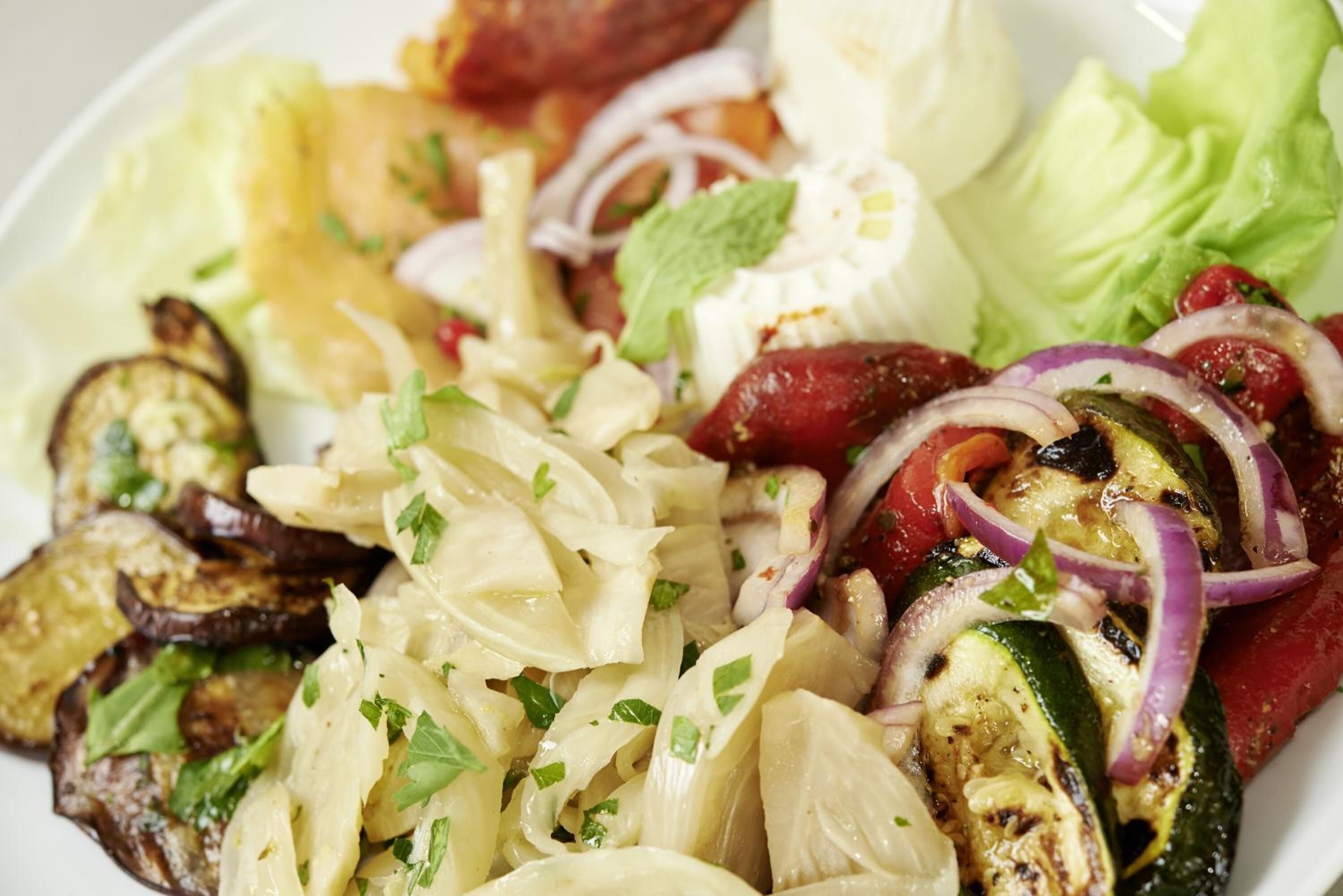 A plate of grilled vegetables and cheese.