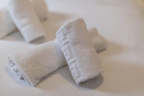 Neatly folded white towels on a bed. - North Circular Studios 5 (Dublin)