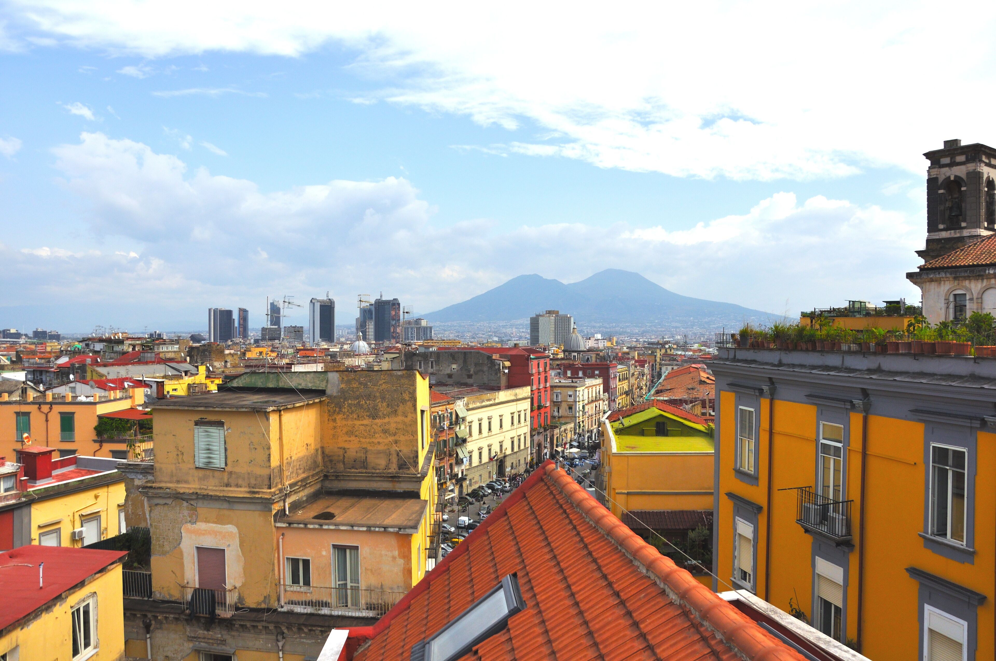 A cityscape with colorful buildings and a mountain in the background.