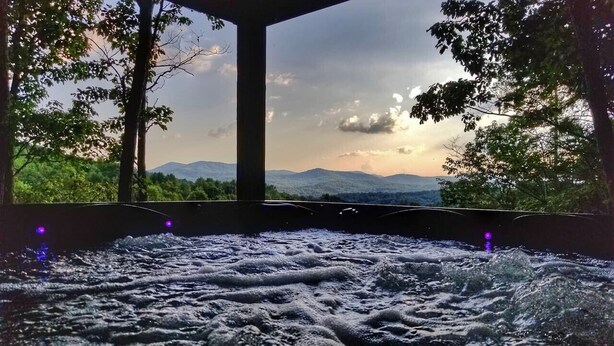 A hot tub with a view of mountains and trees. - Trail`s End-Hot tub-Wi-Fi,-pets ok-Pool Table-Fireplace-Screened Porch-Activities (Morganton)