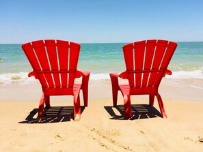 Two red chairs facing the ocean on a sandy beach. - Promo - Awesome  -Beach Front Villa on Sandy Beach  - Hi Speed Wi-Fi (San Felipe)
