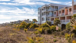 A beachfront residential building with multiple balconies and a 'No Parking' sign. - Seacoast 7- Top Floor Villa - Unobstructed Ocean Views - Elevator (Folly Beach)