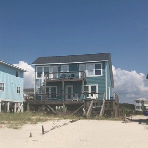 Enjoy stunning beach views from the spacious deck of this beachfront property.