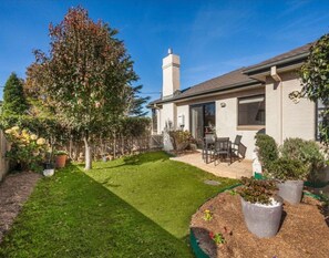 Enjoy the serene atmosphere of this beautifully maintained home with a patio and lush garden.