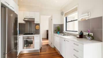 Enjoy cooking in this well-equipped kitchen with a refrigerator, oven, and stove.