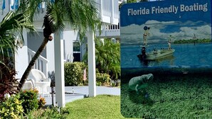Un resort con un cartel que anuncia 'Florida Friendly Boating', con un bote y un hombre pescando.
