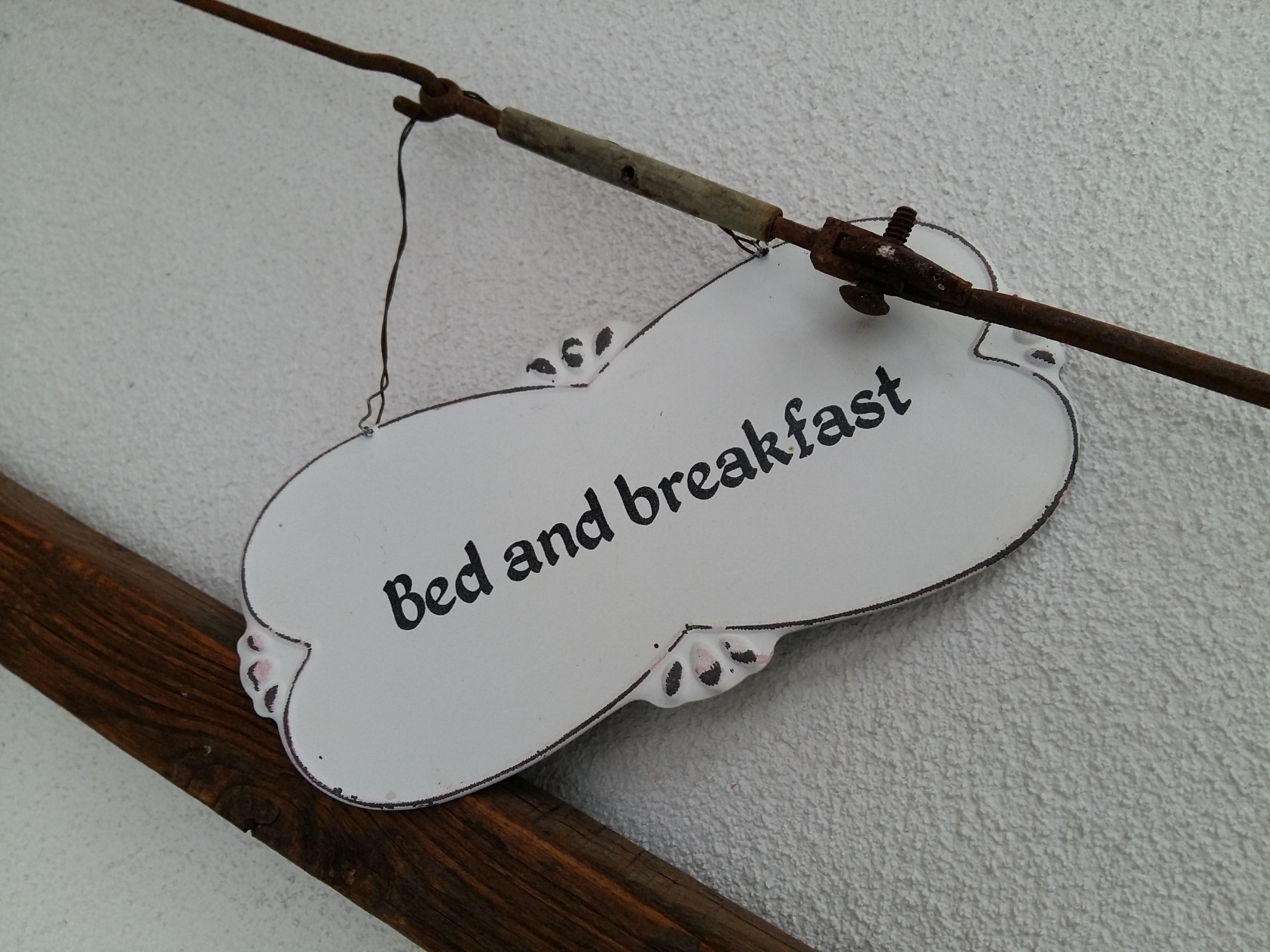 A sign with the text "Bed and breakfast" on a white background with a brown border.