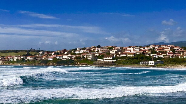 A coastal town with buildings along the shoreline.
